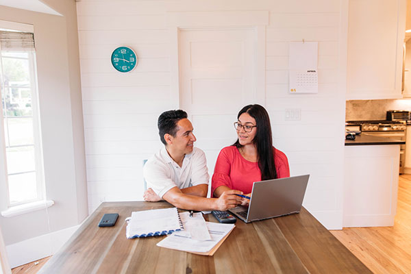 Couple reviewing taxes at kitchen table
